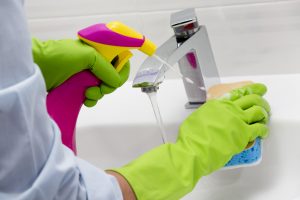 Cleaning - cleaning bathroom sink with spray detergent - housewo